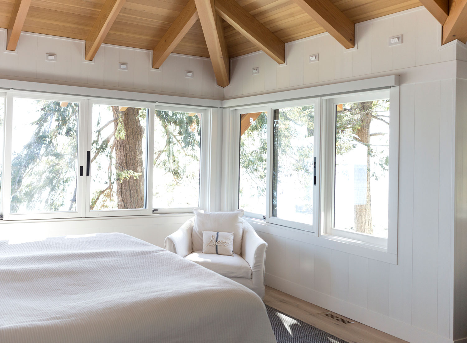 white wooden bedroom walls painted white with large windows