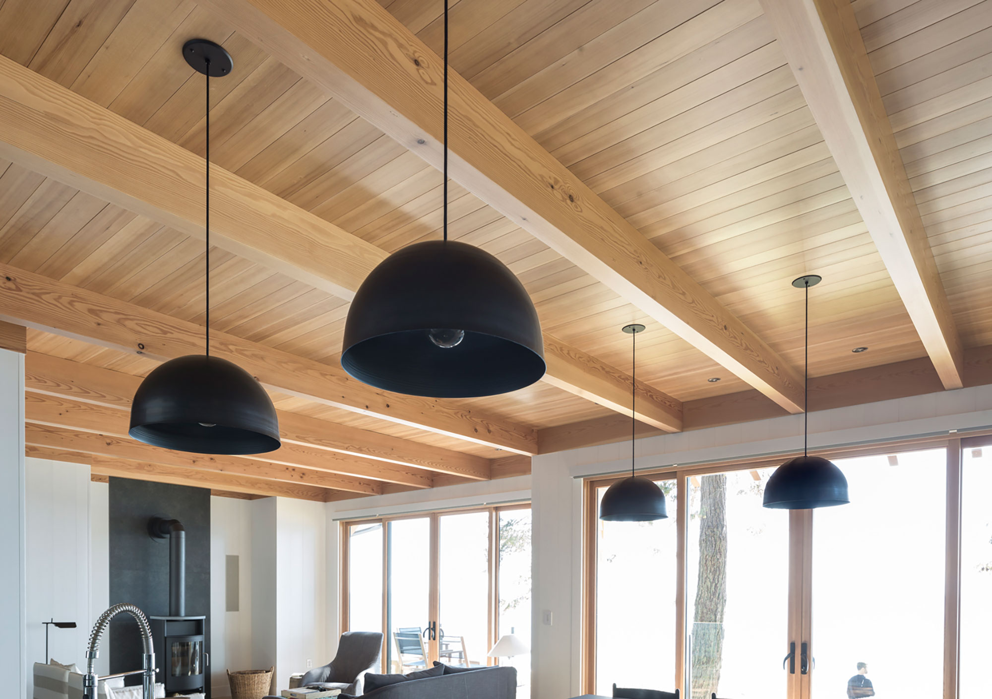 Pacific HemFir Timbers ceiling with modern black lamps handing from it